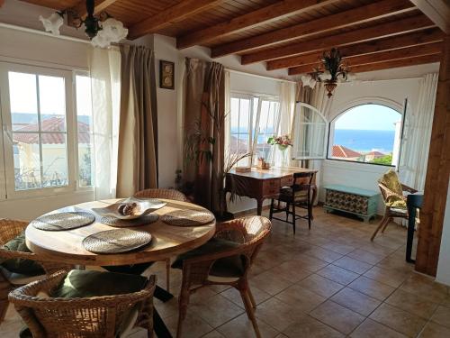 a living room with a wooden table and chairs at Casa Chloe Jandía in Morro del Jable