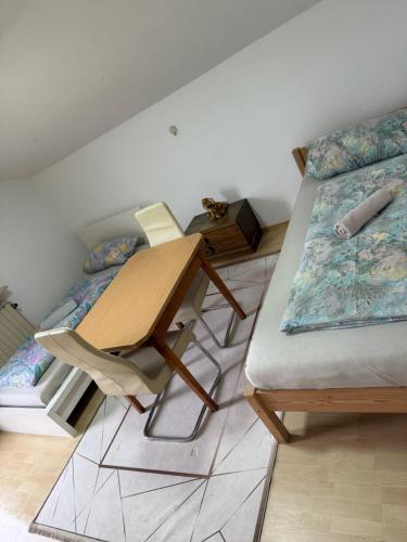 a room with two beds and a table in it at OH 4 in Dornbirn