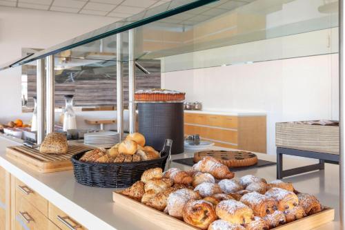 a kitchen with a bunch of pastries on a counter at B&B Hotel Cherasco Langhe in Cherasco
