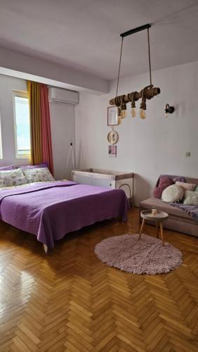 a bedroom with a purple bed and a rug at Jana's Apartment,100 meters to the lake,Free Parking in Ohrid