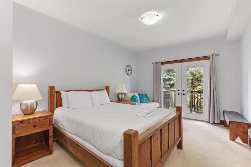 a bedroom with a large bed and a window at Chalet at Blue in Blue Mountains