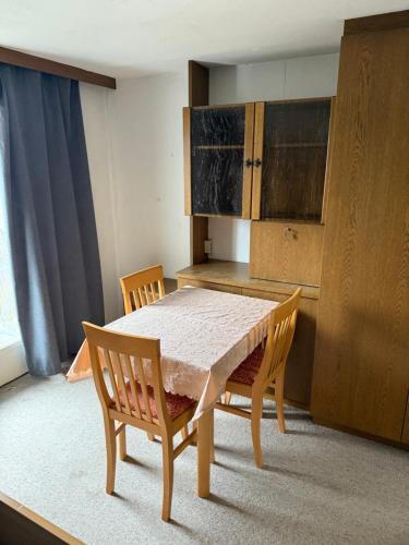 a kitchen with a table and two chairs and a table and cabinets at OH 4 in Dornbirn