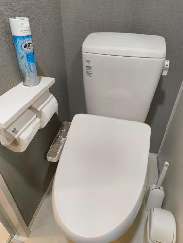 a bathroom with a white toilet in a stall at KamaKama Stay in Tokyo