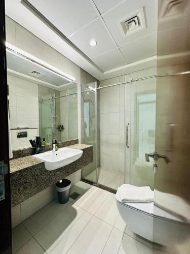 a bathroom with a sink and a toilet and a shower at Peaceful 1BR - Near DIFC & Trade Center and Downtown in Dubai