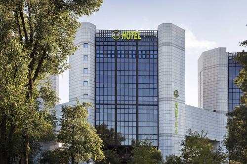 a building with a sign on the side of it at B&B Hotel Milano Cenisio Garibaldi in Milan