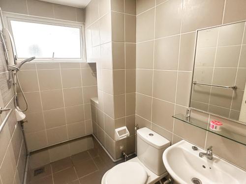 a bathroom with a toilet and a sink at Cozy Home TTDI Adina, Section 13, Shah Alam in Shah Alam
