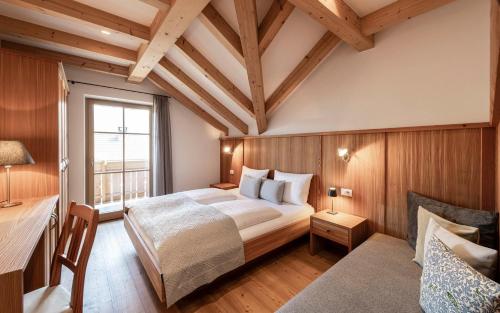 a bedroom with a large bed and a window at Christlrumerhof in Brunico