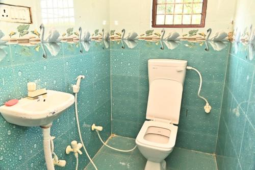 a bathroom with a toilet and a sink at Royal hotel in Hardoī
