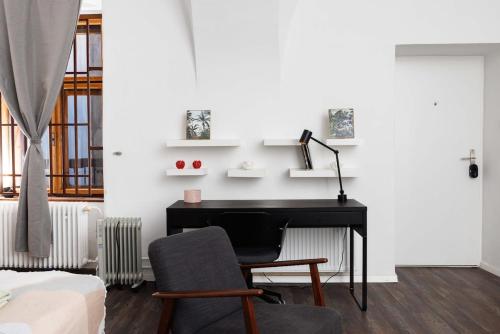 a bedroom with a desk and a chair and a bed at Cute Apartment in the heart of Old Town in Košice