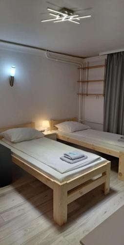 two beds sitting in a room with at ETNA 2 - Parter- Rzeszów , Chrobrego in Rzeszów