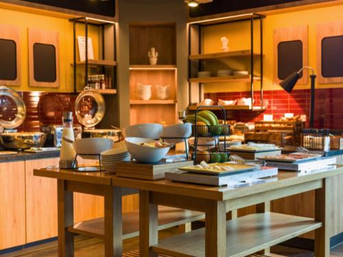 a kitchen with a table with bowls and plates on it at B&B HOTEL Ipswich in Ipswich