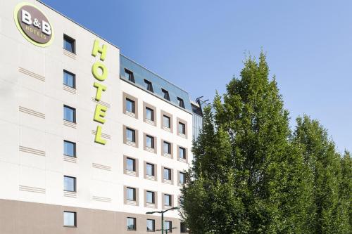 a hotel with a sign on the side of a building at B&B Hotel Milano-Monza in Monza