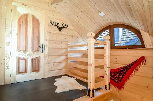 a log cabin with a bunk bed in a room at Bukowiańska Osada in Bukowina Tatrzańska