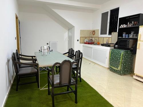 a kitchen and dining room with a table and chairs at Dar diyafa kannoua in Tangier