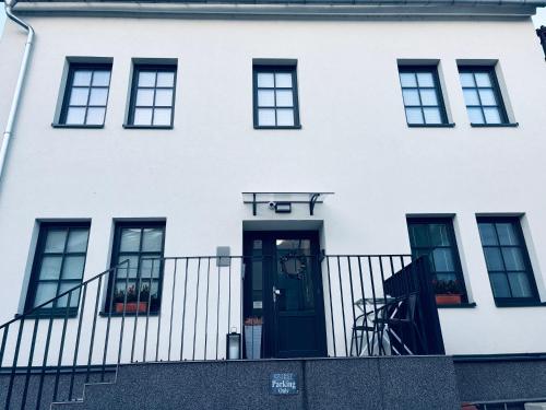 a white house with a blue door at Apartmány Atrium in Litoměřice