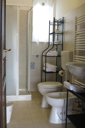 a bathroom with a toilet and a shower and a sink at Dimora del Sole in Putignano