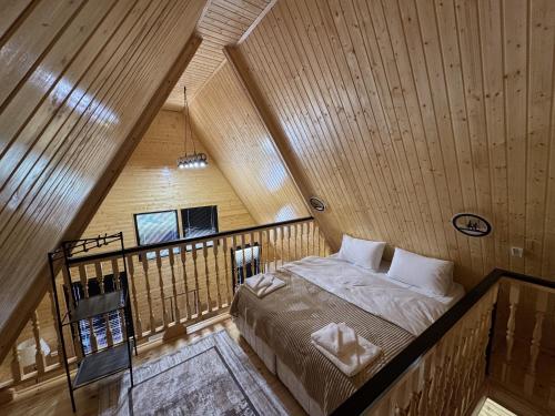 a bedroom with a bed in a wooden room at Aroma of the forest in Martvili