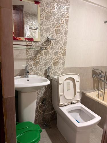 a small bathroom with a toilet and a sink at Hacos Nepal stay in Bhaktapur