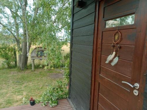 a wooden door to a house with a yard at Casa Nina in Camet Norte