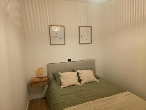 a bedroom with a bed with two pillows on it at Sweet Dreams Olivares in Talavera de la Reina