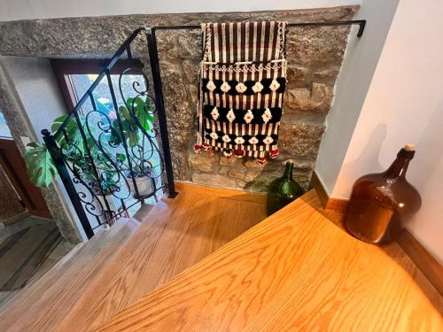a wooden table with two bottles on a wall at Casa d'Abó Anica in Miranda do Douro