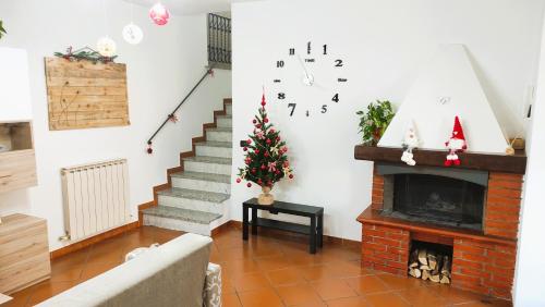 a living room with a christmas tree and a fireplace at La Casa Col Portico in Leivi