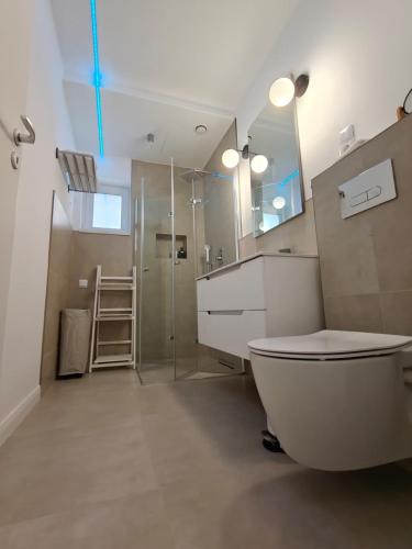 a bathroom with a toilet and a glass shower at Home Ready in Sibiu