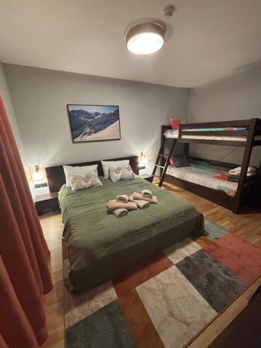 a bedroom with a bed with two bunk beds at Ski-in Flat Next to Ski Road at Mountain View in Bansko