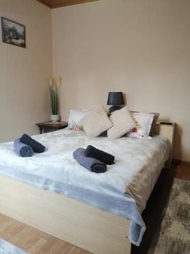 a bedroom with a large bed with blue towels on it at Уют in Haskovo