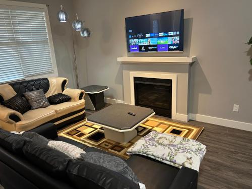 a living room with a couch and a fireplace at Family friendly home at Chappelle garden in Edmonton
