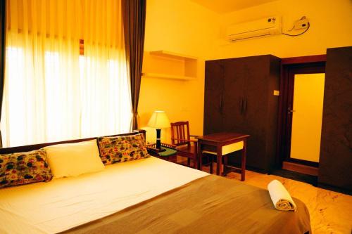 Ένα ή περισσότερα κρεβάτια σε δωμάτιο στο Sandra Suite Ranga illam