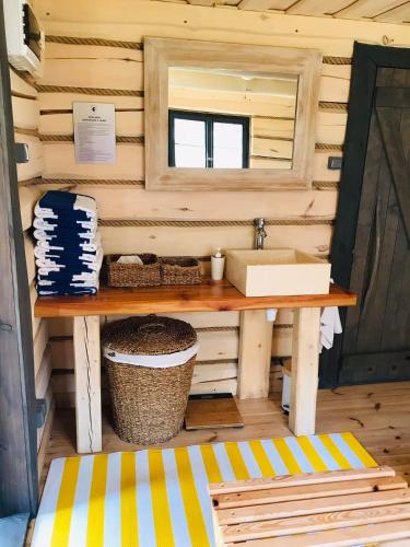 a bathroom in a tiny house with a sink at Farma Noe - Agroturystyka in Lipnica