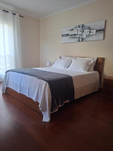 a bedroom with a large bed with white sheets at Paradise Valley Ponta do Sol in Ponta do Sol
