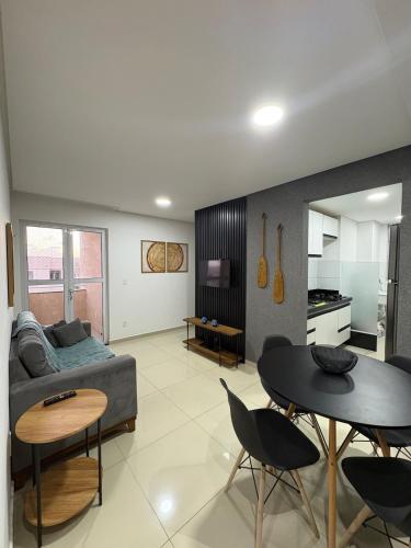 a living room with a couch and a table at Refúgio na praia - Ap para locação por temporada in Parnamirim