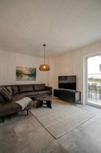 a living room with a couch and a table at betterplaces Homes - Frontenhausen in Frontenhausen