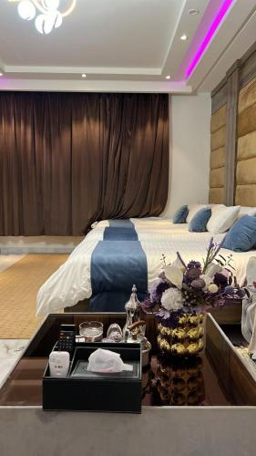 a hotel room with a bed and a table with food at نيروز بارك in Najran