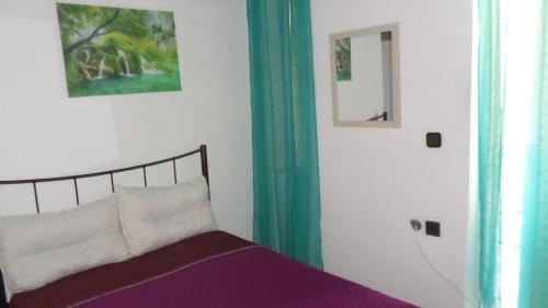 a bedroom with a bed and a mirror at Summer Holidays Studio in Chania