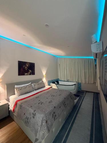 a bedroom with a bed and a tub in it at Hotel Bardhi in Kuçovë