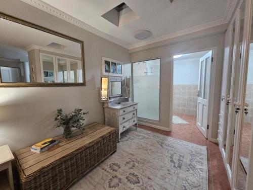 a living room with a couch and a mirror at Villa Zoe in Glencairn
