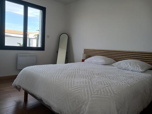 Ένα ή περισσότερα κρεβάτια σε δωμάτιο στο appartement individuel T2