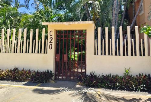 a gate to a house with a fence at Casa en Ixtapa in Ixtapa
