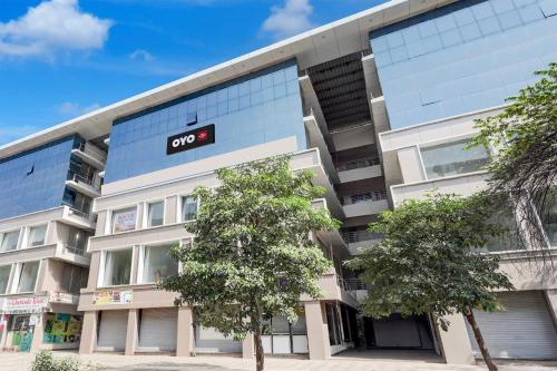 an apartment building with an open sign on it at SPOT ON Hotel The Comfort Cove in Rānder