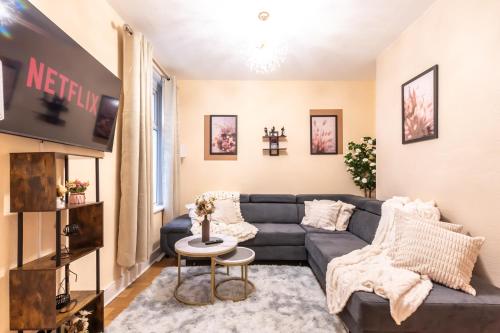 a living room with a couch and a tv at Open Mind Property - Hot Tub , Garden , 3 Bedroom in Portsmouth