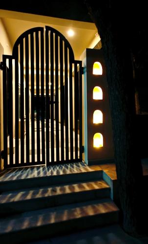 a set of stairs with a gate and lights at The Jungle Gate Villa in Udaipur