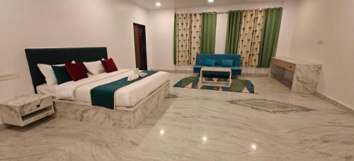 una camera da letto con un letto grande e una sedia blu di The Jungle Gate Villa a Udaipur
