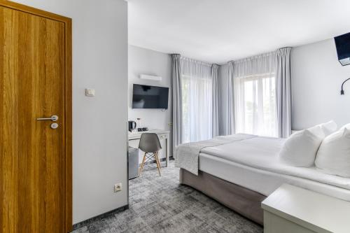 a hotel room with a bed and a desk at Hotel Aqua Sopot - Destigo Hotels in Sopot