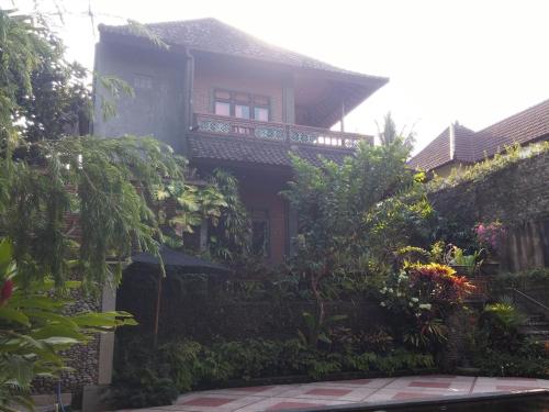 a house with a balcony on the side of it at Vacation home with pool in Ubud, Bali in Ubud