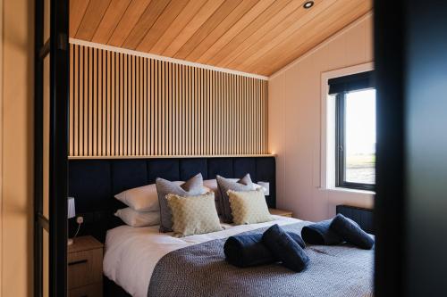 a bedroom with a large bed with pillows on it at Old Fargie Lodges in Perth