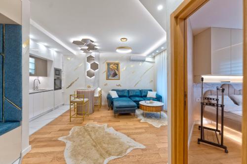 BukorovacにあるQueen Lidijaの青いソファとキッチンのあるリビングルーム