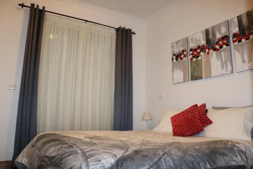 a bedroom with a bed and a large window at Uptown Madalenas in Funchal